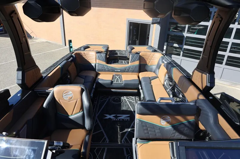 Slide: The Image of 2024 Tigé Ultré 25ZX boat interior with luxurious seating and modern design. - 27