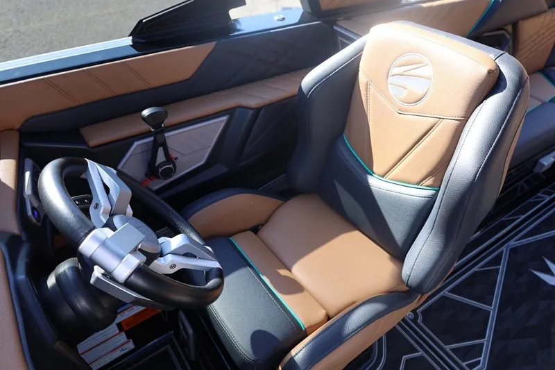 Slide: The Image of 2024 Tigé Ultré 25ZX boat interior with luxury seating and modern steering wheel design. - 28