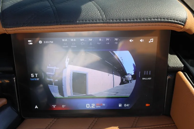 Slide: The Image of 2024 Tigé Ultré 25ZX dashboard display showing rearview camera and control settings. - 33