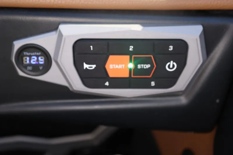 Slide: The Image of Control panel of 2024 Tigé Ultré 25ZX boat with start and stop buttons. - 36