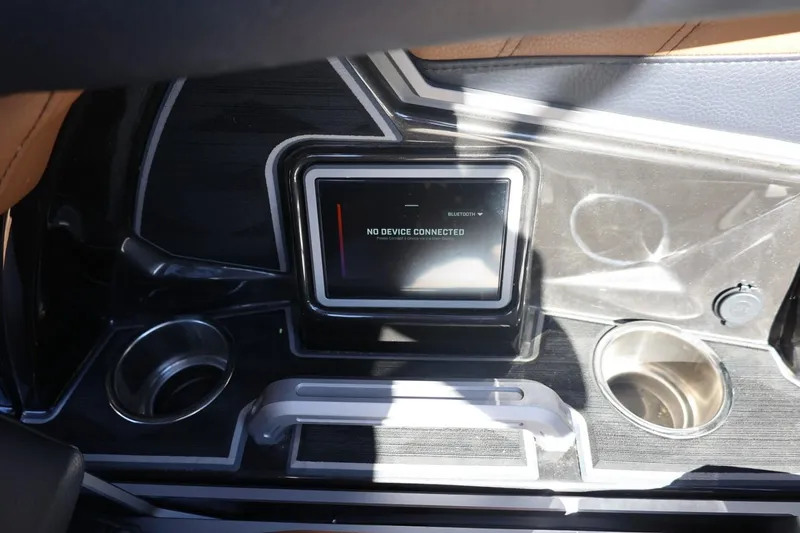 Slide: The Image of 2024 Tigé Ultré 25ZX dashboard with touchscreen display and cup holders. - 40