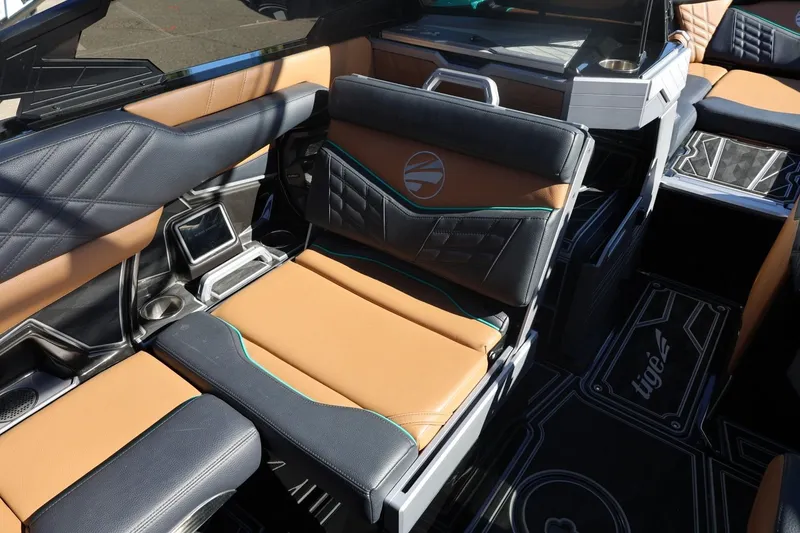 Slide: The Image of 2024 Tigé Ultré 25ZX interior with luxurious tan and black seating. - 44