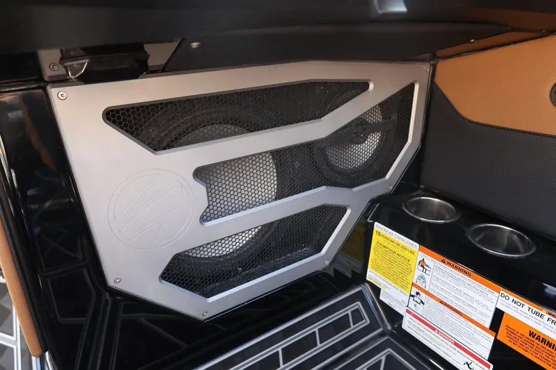 Slide: The Image of 2024 Tigé Ultré 25ZX interior speaker system with safety warnings and cup holders. - 46