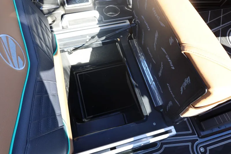 Slide: The Image of 2024 Tigé Ultré 25ZX boat interior storage compartment with stylish seating design. - 53
