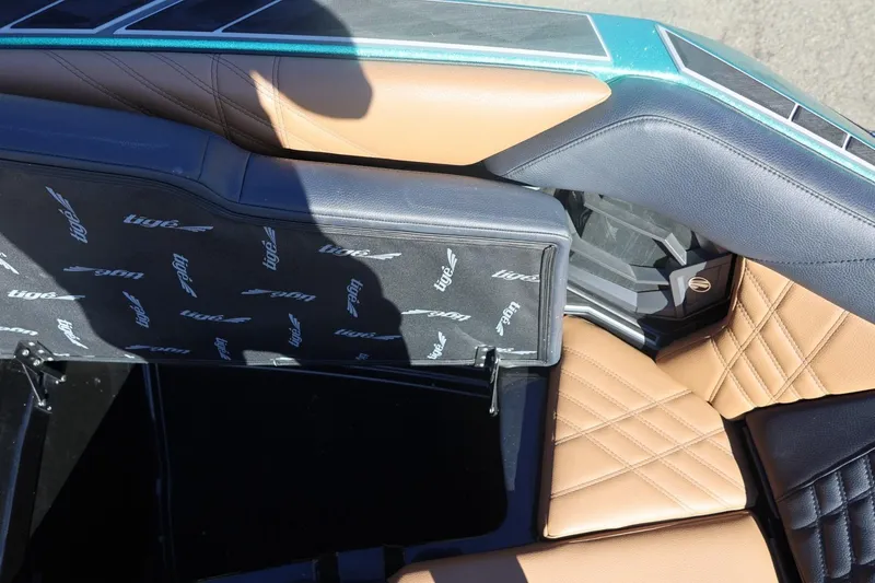 Slide: The Image of 2024 Tigé Ultré 25ZX boat interior with tan and black leather seating. - 55