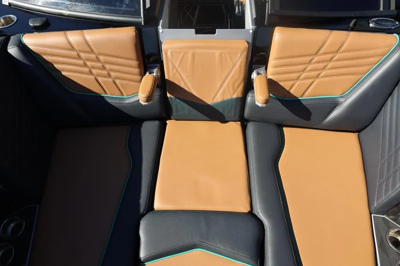 Slide: The Image of 2024 Tigé Ultré 25ZX boat interior with tan and black leather seating. - 58