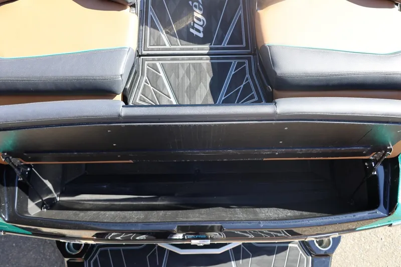 Slide: The Image of 2024 Tigé Ultré 25ZX boat interior with open storage compartment. - 62