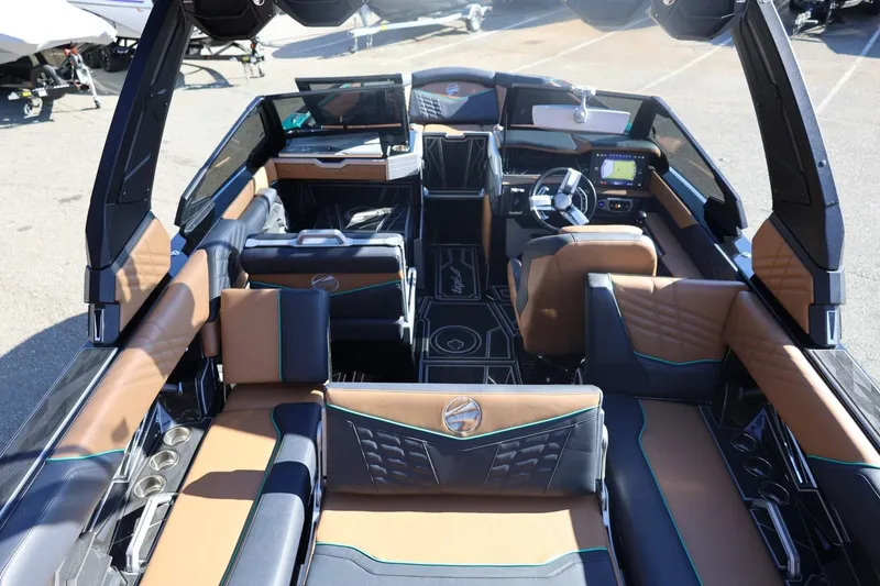 Slide: The Image of 2024 Tigé Ultré 25ZX boat interior with luxurious seating and modern dashboard. - 64