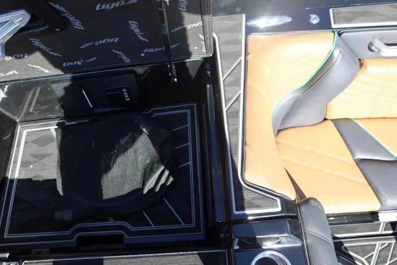 Slide: The Image of 2024 Tigé Ultré 25ZX interior with tan and black seating, stylish design elements. - 66