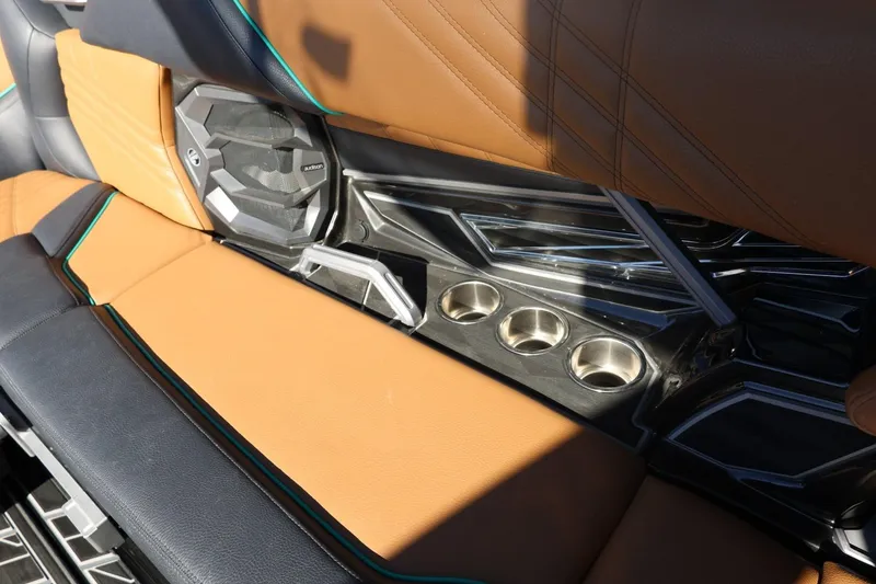 Slide: The Image of 2024 Tigé Ultré 25ZX interior with tan leather seats, cup holders, and speaker system. - 73