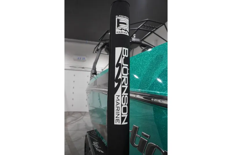 Slide: The Image of 2024 Tigé Ultré 25ZX boat with Bjornson Marine branding in showroom. - 79