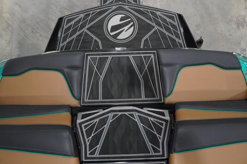 Slide: The Image of 2024 Tigé Ultré 25ZX boat interior with geometric design and brown, black seating. - 86