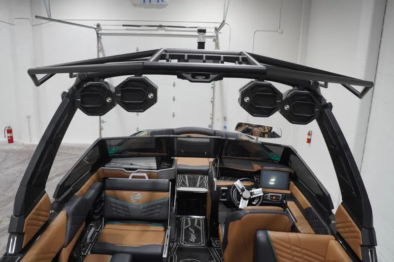 Slide: The Image of 2024 Tigé Ultré 25ZX boat interior with advanced audio system and luxurious seating. - 87