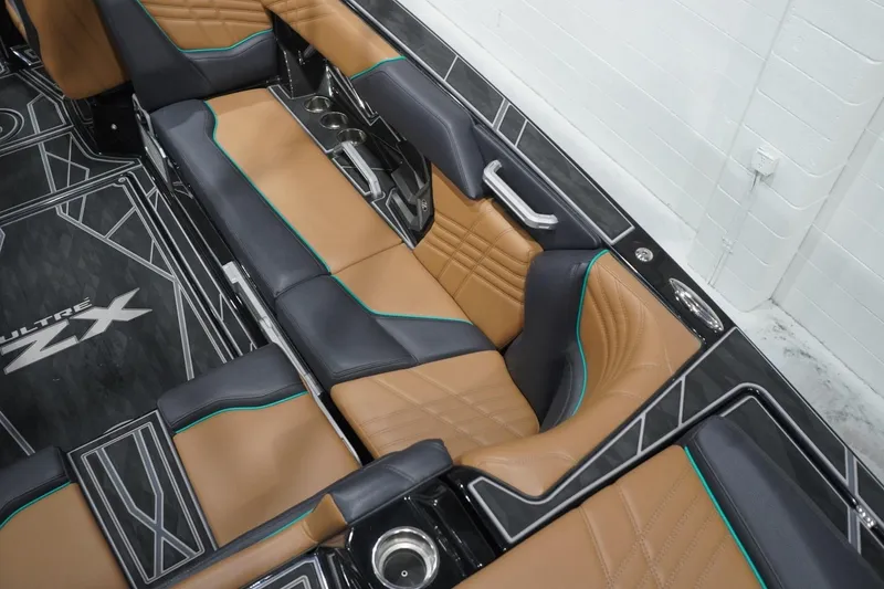Slide: The Image of 2024 Tigé Ultré 25ZX interior with luxurious tan and black seating. - 92