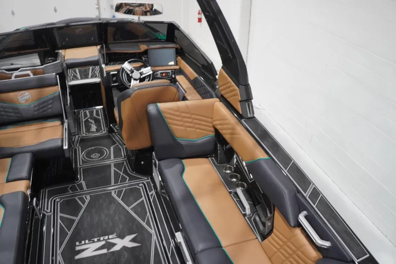 Slide: The Image of 2024 Tigé Ultré 25ZX boat interior with luxurious seating and modern dashboard design. - 93