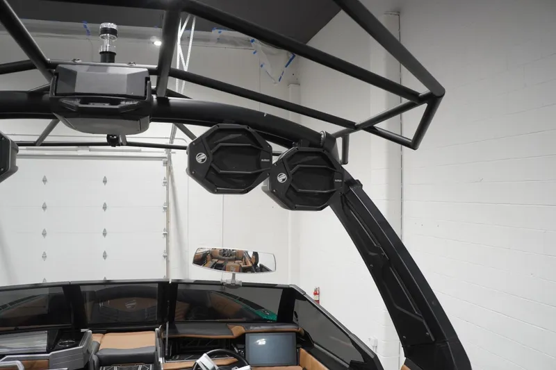 Slide: The Image of 2024 Tigé Ultré 25ZX boat interior with advanced audio system and sleek design. - 94