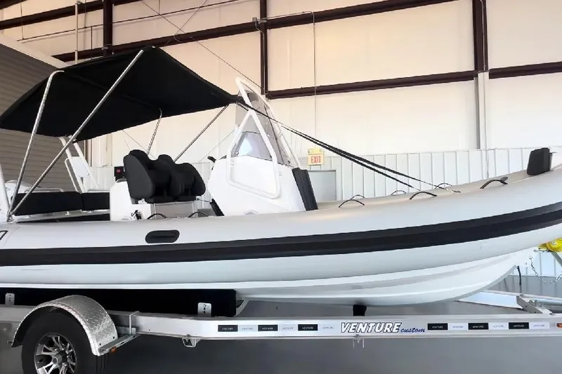 Slide: The Image of 2024 Highfield Sport 660 boat on trailer in indoor storage facility. - 5