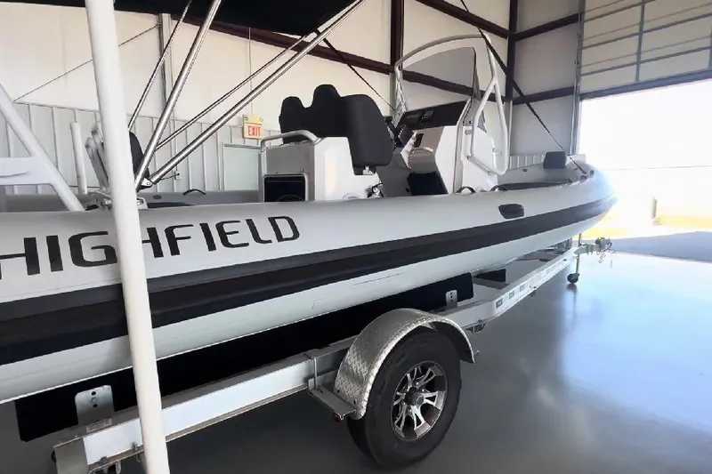 Slide: The Image of 2024 Highfield Sport 660 boat on trailer in a storage facility. - 6