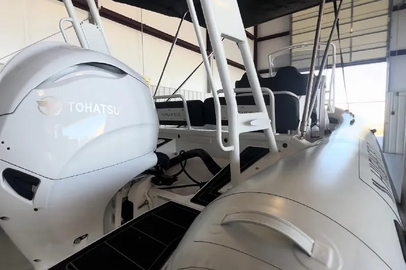 Slide: The Image of 2024 Highfield Sport 660 boat with Tohatsu engine in a warehouse setting. - 7