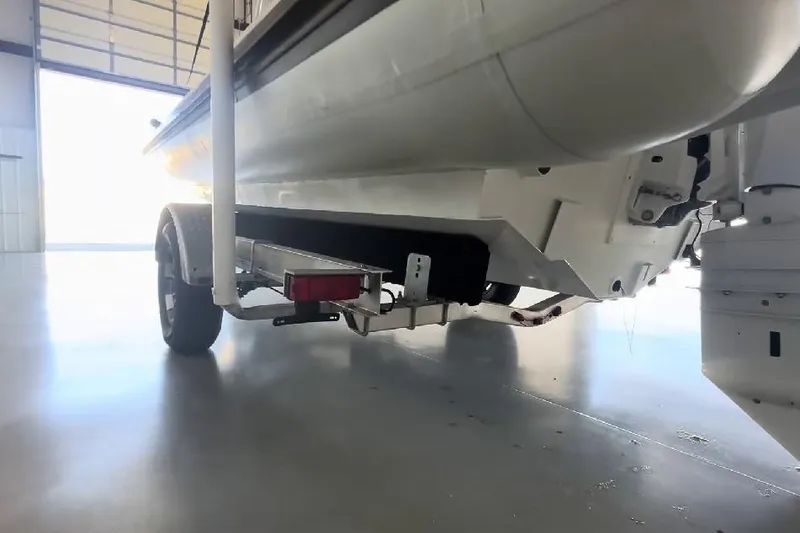 Slide: The Image of 2024 Highfield Sport 660 boat on trailer in a garage setting. - 8