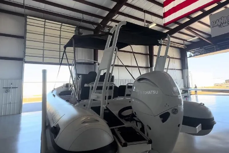 Slide: The Image of 2024 Highfield Sport 660 boat with Tohatsu engine in a warehouse. - 9