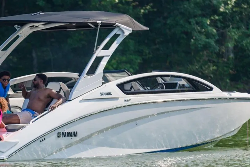 Slide: The Image of 2026 Yamaha Boats 275SE cruising on a lake with passengers enjoying the ride. - 3