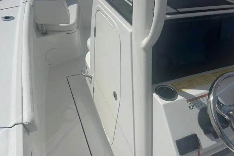 Slide: The Image of 2025 Parker 2200 Center Console boat interior, featuring helm and seating area. - 11