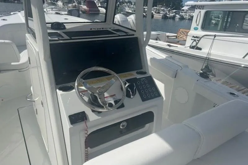 Slide: The Image of 2025 Parker 2200 Center Console boat interior with steering wheel and control panel. - 12