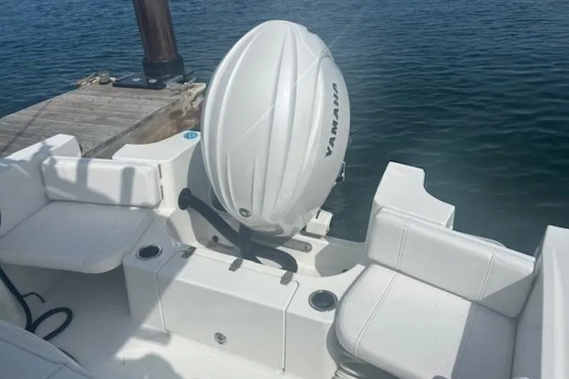 Slide: The Image of 2025 Parker 2200 Center Console boat with Yamaha outboard motor, docked by the water. - 15