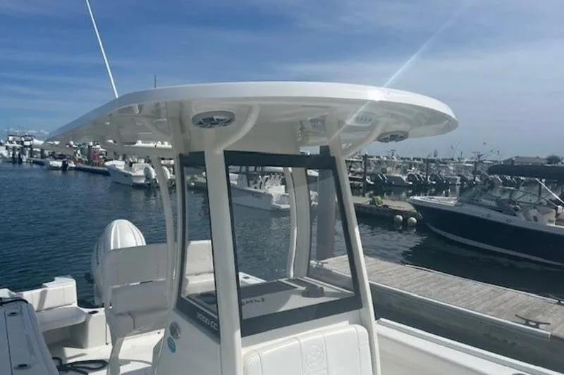 Slide: The Image of 2025 Parker 2200 Center Console boat docked at a marina under clear skies. - 6