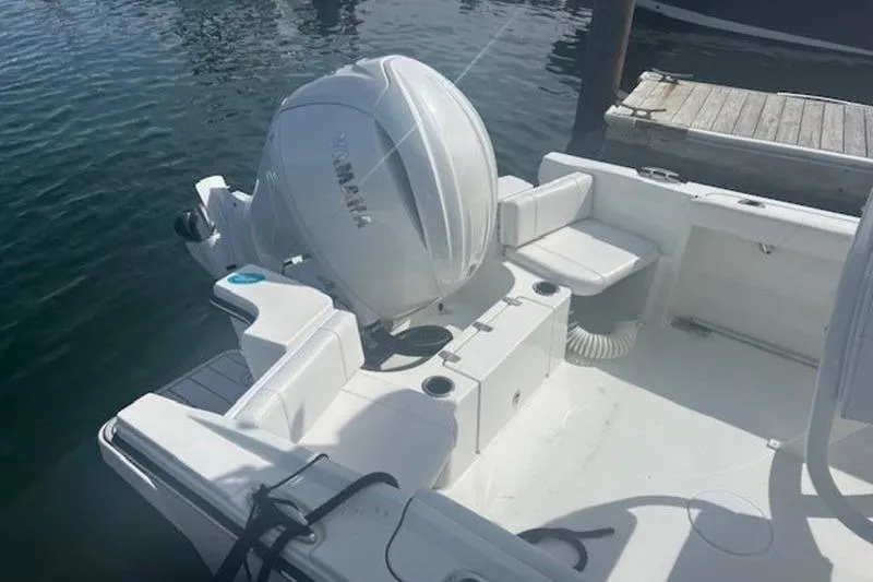 Slide: The Image of 2025 Parker 2200 Center Console boat with Yamaha outboard engine, docked on calm water. - 7