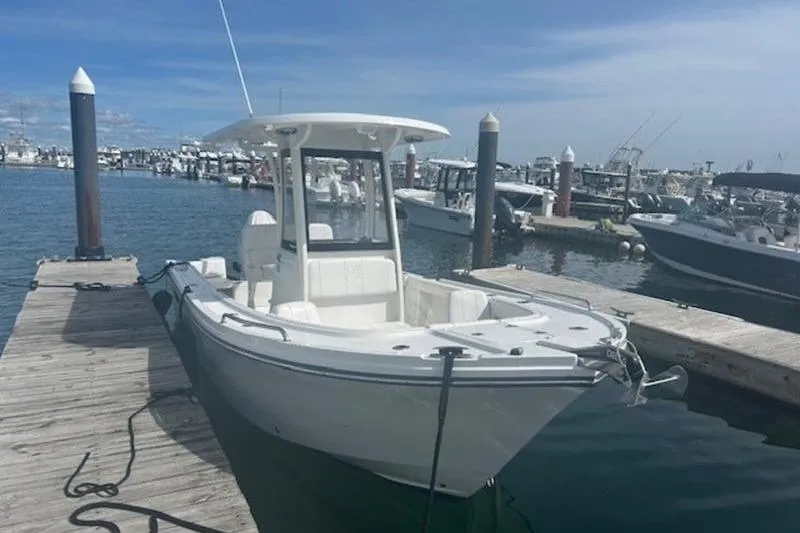Slide: The Image of 2025 Parker 2200 Center Console boat docked at a marina under clear skies. - 8