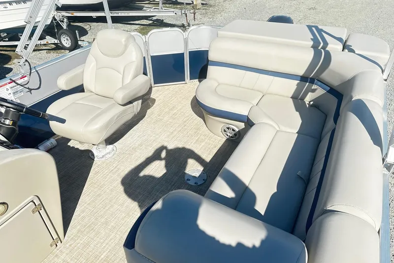 Slide: The Image of 2018 Berkshire 22CL CTS Pontoon interior with beige seating and steering console. - 6