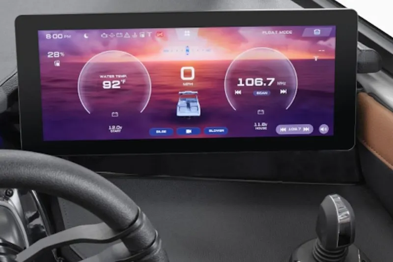 Slide: The Image of 2026 Yamaha Boats 295SE dashboard display showing water temperature and radio controls. - 2