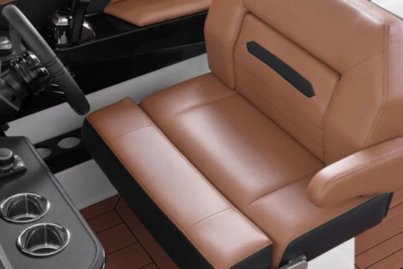 Slide: The Image of Luxurious tan leather seat in 2026 Yamaha Boats 295SE, featuring sleek design and cup holders. - 4