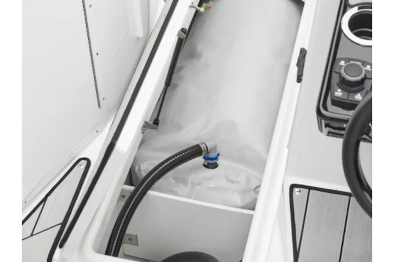 Slide: The Image of 2026 Yamaha Boats 222XE interior storage compartment with hose and control panel. - 4
