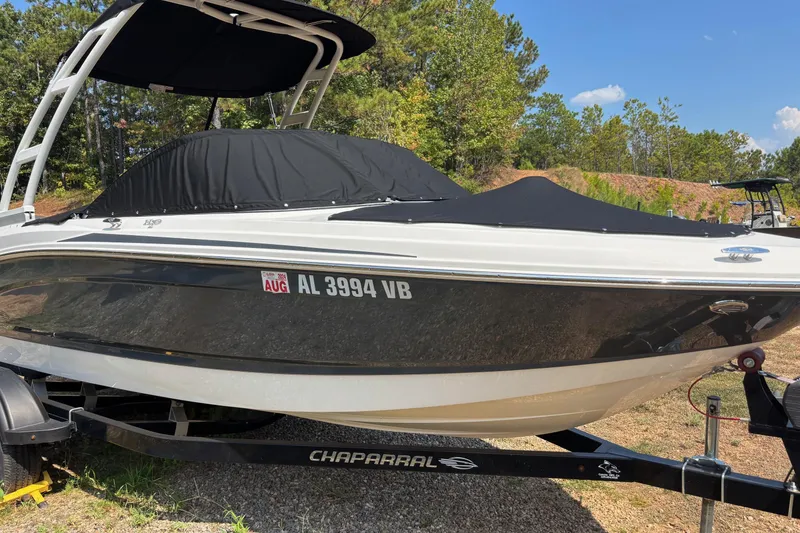 Slide: The Image of 2019 Chaparral 21 H2O Sport boat on trailer, covered and parked outdoors. - 6