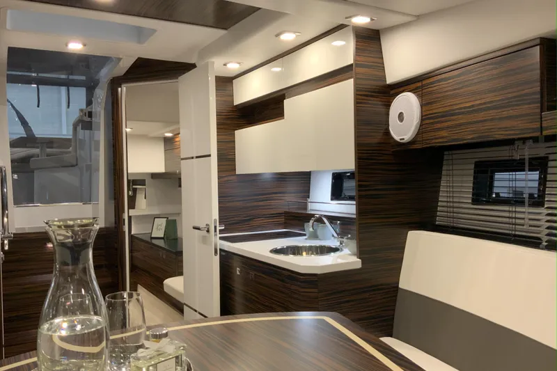 Slide: The Image of Luxurious interior of 2026 Cobrey 33 HT yacht with modern kitchen and seating area. - 5