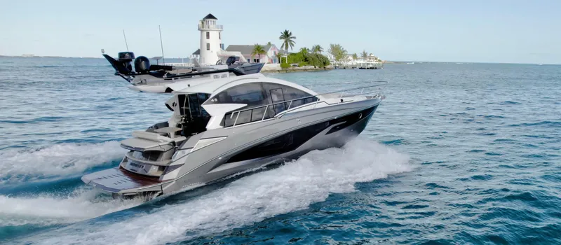 Slide: The Image of 2026 Cobrey 45 Fly yacht cruising near a lighthouse on open water. - 1