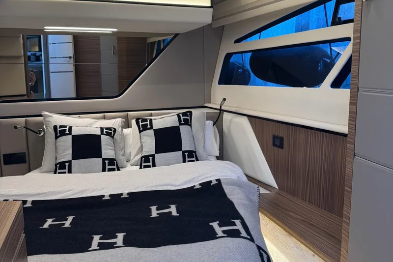 Slide: The Image of Luxurious bedroom interior of 2026 Cobrey 45 FLY yacht with elegant bedding and modern design. - 19