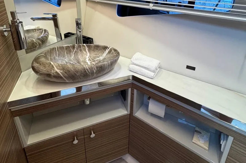 Slide: The Image of Luxurious bathroom in 2026 Cobrey 45 FLY yacht with elegant stone sink and modern fixtures. - 21