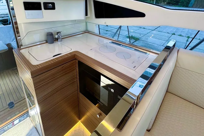 Slide: The Image of Luxurious kitchen area in 2026 Cobrey 45 FLY yacht with modern appliances and sleek design. - 6