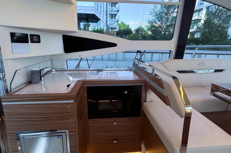 Slide: The Image of Luxurious interior of 2026 Cobrey 45 FLY yacht with modern kitchen and seating area. - 9