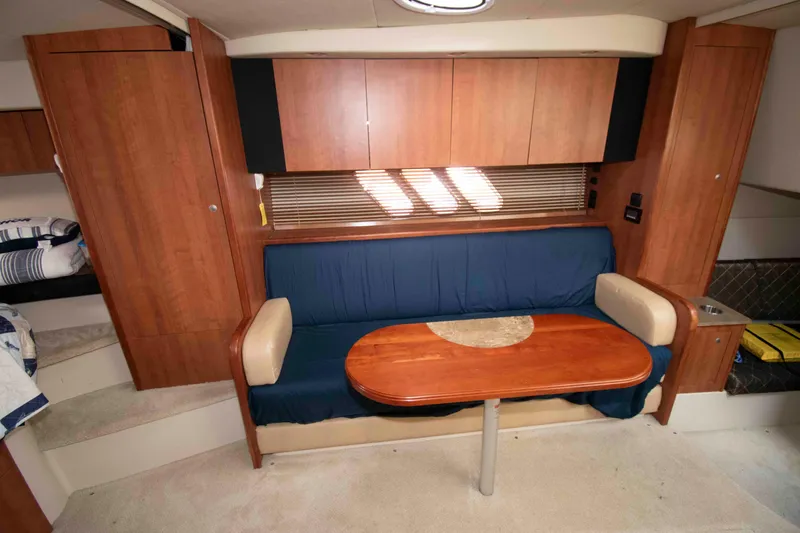 Slide: The Image of Interior of 2011 Cruisers Yachts 360 Express with wooden cabinetry and blue seating. - 13