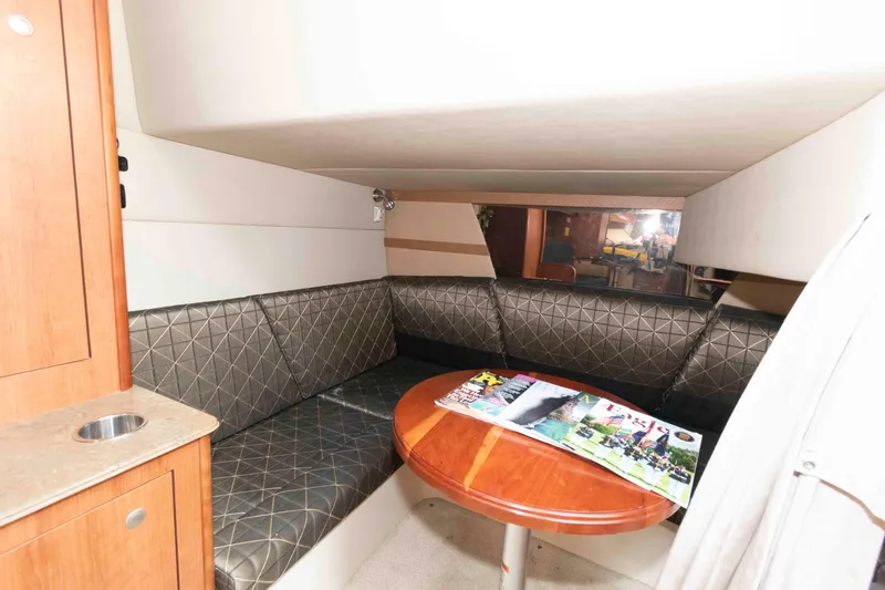 Slide: The Image of Luxurious interior of 2011 Cruisers Yachts 360 Express with cushioned seating and wooden table. - 15