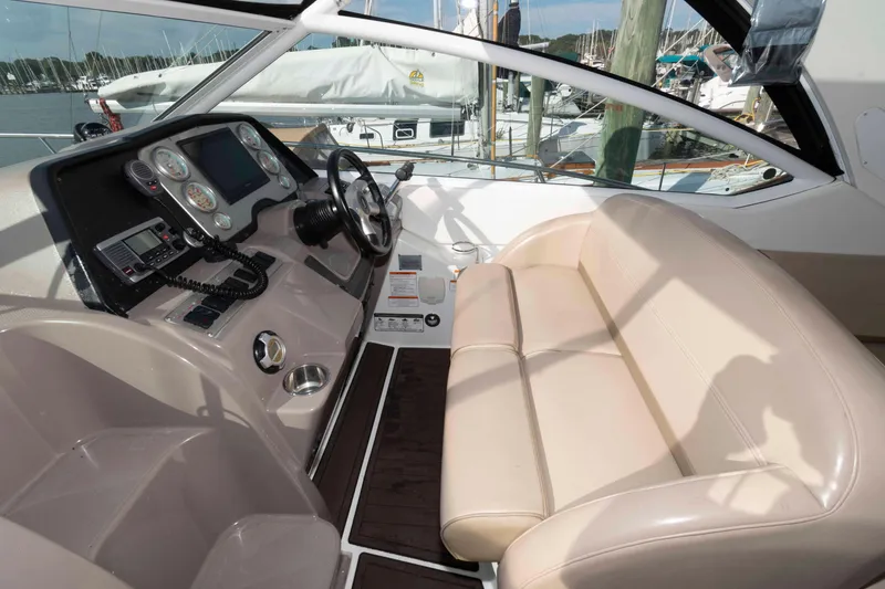 Slide: The Image of 2011 Cruisers Yachts 360 Express helm with beige seating and control panel. - 5