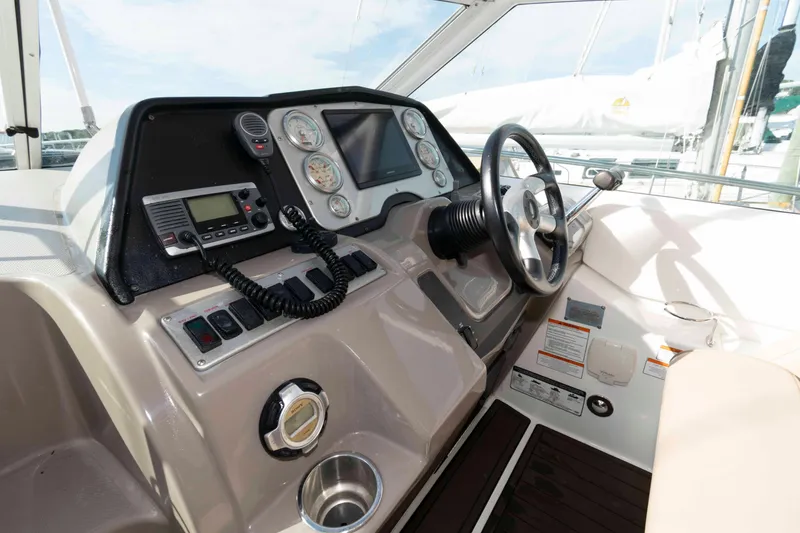 Slide: The Image of 2011 Cruisers Yachts 360 Express helm with steering wheel and navigation controls. - 6