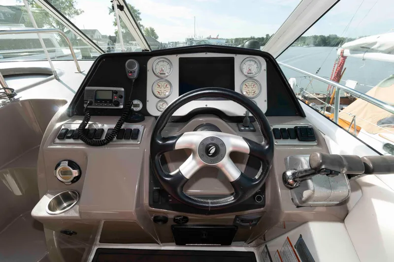 Slide: The Image of 2011 Cruisers Yachts 360 Express helm with steering wheel and control panel. - 7