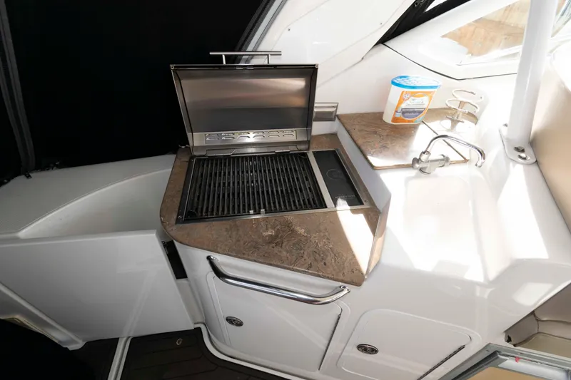 Slide: The Image of 2011 Cruisers Yachts 360 Express interior with grill and sink on countertop. - 10