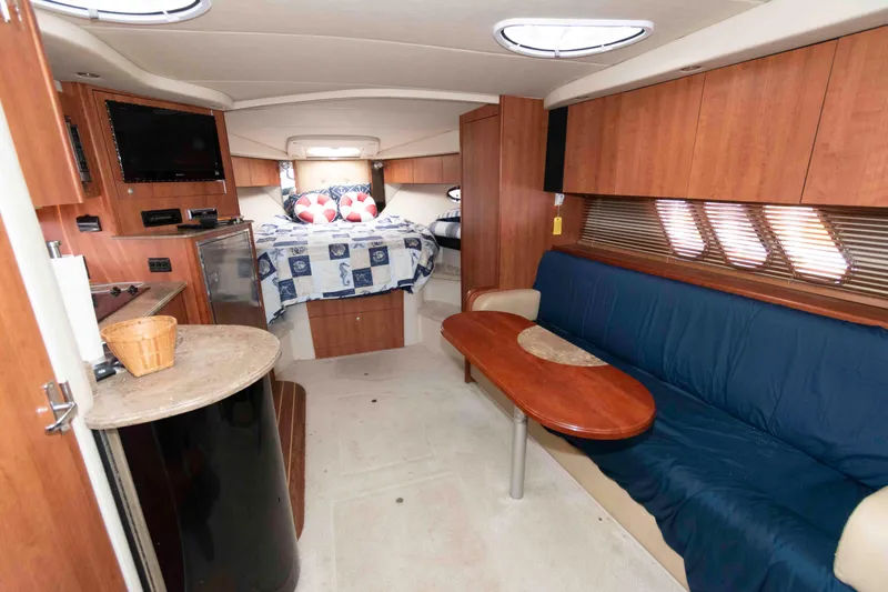 Slide: The Image of Interior of 2011 Cruisers Yachts 360 Express, featuring cozy seating and a compact kitchen area. - 11